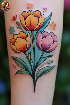 a colorful flower tattoo on the leg with flowers and leaves painted on it's side