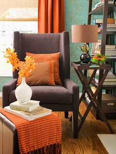 a living room with a chair, table and bookshelf filled with books in it