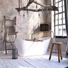 an old fashioned bathtub and stool in a rustic bathroom with exposed wood beams on the wall