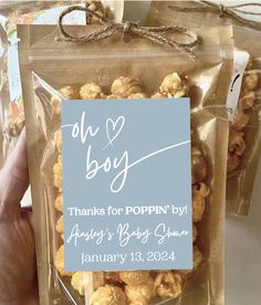 there is a bag of popcorn in the person's hand and it says, oh boy thanks for poppin by always's baby summer