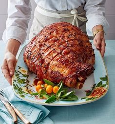 a person holding a large piece of meat on a plate