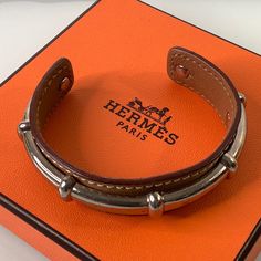 Hermes Bracelet Agatha Design Name Size Os Measurements Are Shown In The Photos In Excellent Used Condition From A Smoke Free Home Stamped On The Leather And Stamped At The End Of The Cuff Includes Bust / Polishing Bag, Box And Ribbon Please Look At All The Pictures For Details Since They Are Part Of The Description And Don’t Hesitate To Ask Me Any Questions. Thank You Luxury Brown Bangle Bracelet, Designer Brown Adjustable Bracelet, Designer Adjustable Brown Bracelet, Luxury Brown Leather Strap Bracelets, Luxury Leather Bangle Jewelry, Luxury Brown Bracelets With Leather Strap, Timeless Brown Bracelet Strap Jewelry, Designer Adjustable Leather Bracelet, Timeless Brown Jewelry With Bracelet Strap