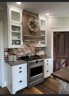 a kitchen with white cabinets and an oven