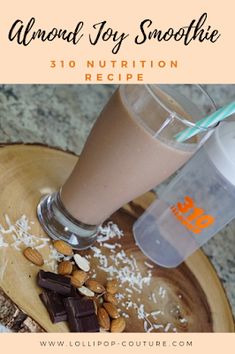 almond joy smoothie on a wooden plate with nuts and milk in the background text reads almond joy smoothie 30 nutrition recipe