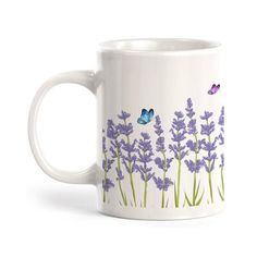 a white coffee mug with purple flowers and butterflies on the outside, in front of a white background