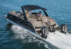 a motor boat with two people riding in the water on it's back end