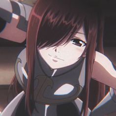 an anime character with long red hair and black eyes, holding her arms behind her back