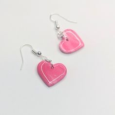 Add a touch of whimsy to your outfit with these Sparkly Pink Marbled Heart Drop Earrings. Made with lightweight polymer clay, they won't weigh you down and are perfect for everyday wear. The sparkly pink marbled design is sure to catch the eye and add a playful pop to any look. All orders are packaged with care. Each box includes tissue paper, a tealight and a KelZo postcard. Product details: Polymer clay Approx 4cm Hypoallergenic stainless steel hooks ****Colours may vary slightly from image due to resolution differences. Colour patterns may not match photographed item but will be cut from same piece/collection. Shapes and sizes may also vary due to the nature of handmade products.*** Care and Returns Please handle your KelZo Jewellery with care, as it is handmade and more fragile compare Pink Resin Heart Earrings For Gift, Pink Resin Heart Earrings As Gift, Pink Heart Resin Earrings, Pink Nickel-free Heart Earrings For Valentine's Day, Pink Hypoallergenic Jewelry For Valentine's Day, Pink Resin Heart Earrings Handmade, Pink Resin Heart Earrings, Nickel-free Pink Earrings For Everyday, Handmade Pink Resin Heart Earrings