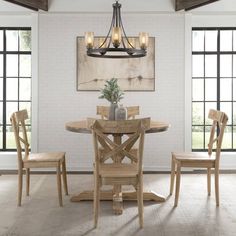 a dining room table with four chairs around it