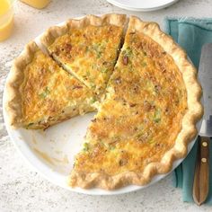 a quiche on a plate with one slice missing