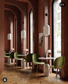 an empty restaurant with green chairs and white tables