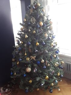 a decorated christmas tree in the corner of a room