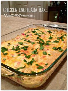 chicken enchilada bake in a glass casserole dish with green garnish