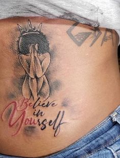 a woman's stomach with the words believe in yourself written on it and a crown above her belly