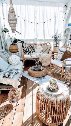 a living room filled with lots of wicker furniture next to a white curtained window