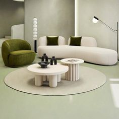 a living room filled with white couches and green chairs