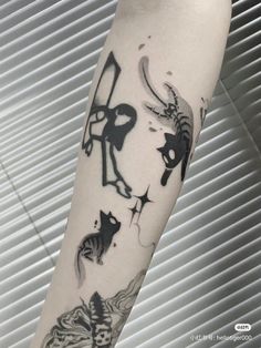 a person with a tattoo on their arm that has cats and other animals in it