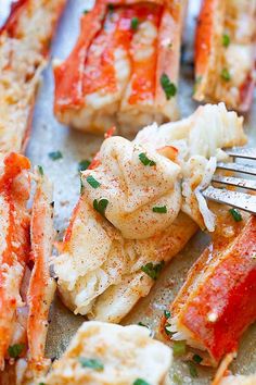 there is a fork that is on top of some lobsters and cauliflower