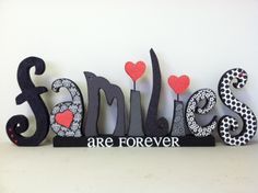 the word smile is made up of letters with hearts and flowers on them in black and white