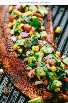 grilled fish with vegetables and corn on the grill