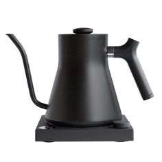 a black coffee pot sitting on top of a stove