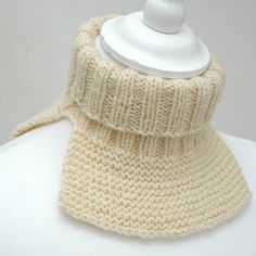 a white knitted neck warmer on top of a mannequin's head