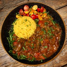 a plate with rice, meat and vegetables on it