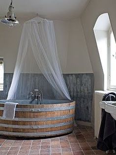 an old fashioned bathtub in the middle of a bathroom