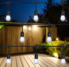 an outdoor deck with lights strung from it