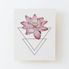 a pink flower is on top of a triangle