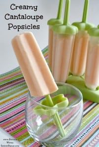 three ice cream popsicles sitting on top of a glass bowl next to each other