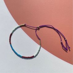 "Handmade colorful patterned Bracelet on 100% Griffin natural fine silk thread. Made with handmade Japanese high quality Miyuki glass beads in a modern cylinder shape. Adjustable size bracelet with sliding gold filled bead at center back. Slides over hand and then is easily tightened by sliding the bead at the back to a comfortable fit. Also available as an anklet. Great for wearing while doing daily activities, yoga, fitness, since it is so lightweight it hardly feels like you have anything on.  Unisex bracelet, looks great on everyone. Perfect everyday bracelet, looks great layered. -Fits wrist size  5\" - 7\"  Bracelet opening adjustable from  5\" - 9\" opening -Anklet 9\" - 11\" **Please note on order if you would like the Anklet Size otherwise bracelet size will be made. ** If you nee Multicolor Heishi Beads Bracelet With Sliding Knot, Handmade Minimalist Multicolor Beaded Bracelets, Multicolor Handmade Minimalist Beaded Bracelets, Minimalist Handmade Multicolor Beaded Bracelets, Minimalist Multicolor Handmade Beaded Bracelets, Multicolor Beaded Necklace With Adjustable Length As Gift, Multicolor Beaded Necklace With Adjustable Length, Multicolor Adjustable Beaded Necklace Gift, Minimalist Multicolor Round Bead Friendship Bracelets