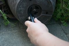 someone is removing the tire from their car's rim with two tongs on it