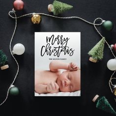 a christmas card with a baby laying on it