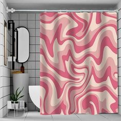 a pink and white shower curtain in a bathroom