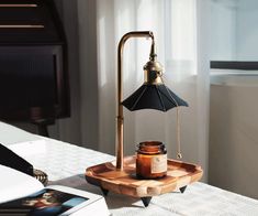 a table lamp sitting on top of a wooden tray next to a jar of honey