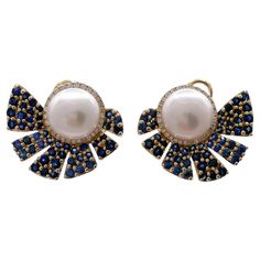 Jay Feder 14k Yellow Gold Pearl Sapphire Diamond Earrings Total carat weight of blue sapphires is 3.24ct. Total carat weight of diamonds is 0.29ct. The pearls are 10.25mm in diameter. Each earring measures to 23.72x20.58mm. The total weight is 12 grams. Great condition, no major signs of wear. Polished and ready to wear. All Returns and exchanges must be authorized by the seller within 3 days of delivery. Merchandize may be returned for exchange or store credit within 30 days of purchase. Items which have been worn, sized, or otherwise altered, any special order or custom designed item, sold at reduced pricing as Final Sale items may only be returned or exchanged at Jay Feder Jewelers discretion. All items are shipped via FedEx or UPS insured; signature required. International buyers: Plea Diamond And Pearl Earrings, Sapphire Diamond Earrings, Sapphire And Diamond Earrings, Pearl And Diamond Earrings, Gold Pearl, Sapphire Diamond, Blue Sapphire, Sale Items, Final Sale