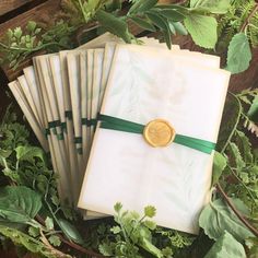 a bunch of papers that are sitting on some leaves