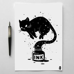 a black cat sitting on top of a jar of ink