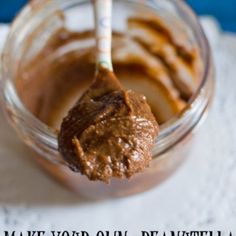 a spoon full of peanut butter on top of a napkin with the words make your own peanut butter