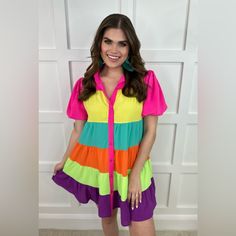 Jess Lea Rylee Women’s Rainbow Dress. Get Ready To Make A Statement With Our Rylee Rainbow Dress! This Tiered Multicolored Dress Is Not Only Stylish, But Also Functional With Its Button Down Design And Convenient Pockets. And With Its Playful Puff Sleeves And Trendy Collar, You'll Be The Center Of Attention Wherever You Go. Order Now And Be The First To Rock This Colorful And Fun Dress! Nwt. Brand New, Never Worn. In Excellent Condition. Brand: Jess Lea Color: Multi Size: Large 97% Polyester, 3% Vibrant Multicolor Short Sleeve Mini Dress, Purple Short Sleeve Mini Dress For Day Out, Purple Mini Dress With Short Sleeves For Day Out, Fun Short Sleeve Dresses For Day Out, Fun Multicolor Mini Length Dresses, Cute Multicolor Mini Dress With Short Sleeves, Purple Short Sleeve Summer Mini Dress, Cute Purple Short Sleeve Dress, Summer Purple Short Sleeve Dresses