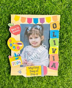 a child's first day of school photo frame on grass with the words, back to school