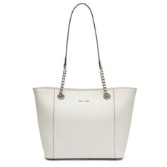 Glistening Chain-Links Brighten The Ample Handles Of A Pocket-Lined Calvin Klein Tote Sized For Managing Busy Schedules In Style. Large Sized Bag; 15"W X 10"H X 5"D Silhouette Is Based Off 5'9" Model 14"L Double Handles Zip Closure & Feet Silver-Tone Exterior Hardware & 1 Back Magnetic-Snap Pocket 1 Interior Zip Pocket & 4 Slip Pockets Leather Imported Color: White/Silver Condition: Brand New With Original Retail Tags. Defect: Faint Yellow Mark On Front Of Purse, See Last Photo. Elegant Calvin Klein Shoulder Bag For Daily Use, Elegant Calvin Klein Shoulder Bag With Silver-tone Hardware, Elegant Calvin Klein Evening Shoulder Bag, Elegant Calvin Klein Shoulder Bag For Formal Occasions, Chic Calvin Klein Shoulder Bag With Silver-tone Hardware, Elegant Formal Calvin Klein Bag, Elegant Calvin Klein Formal Bag, Elegant Calvin Klein Office Bag, Elegant Calvin Klein Bags For Office