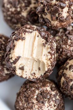 chocolate covered cookies with peanut butter in the middle on a white plate, ready to be eaten