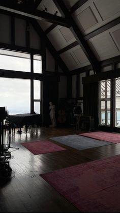 yoga mats are arranged on the floor in front of large windows with panoramic views