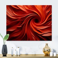 an abstract painting in red and orange on a wall above a table with vases