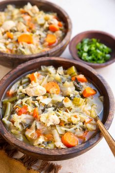 two wooden bowls filled with soup and vegetables