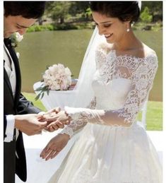 the bride and groom are exchanging their wedding rings