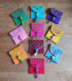 several small pieces of felt sitting on top of a wooden table next to each other