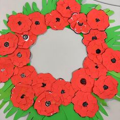 a paper wreath made to look like poppies